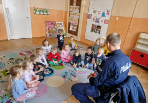 Dzieci słuchają tego co mówi Pan Policjant.