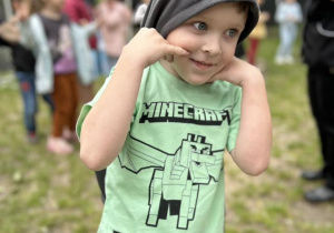 Chłopiec uśmiecha się do zdjęcia.