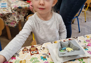 Dziewczynka ozdabia swoje mydełko.