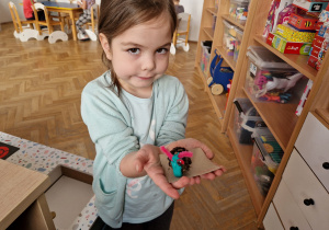Dziewczynka trzyma, wykonanego przez siebie ślimaka.