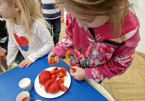 Dzieci degustują pomidory.
